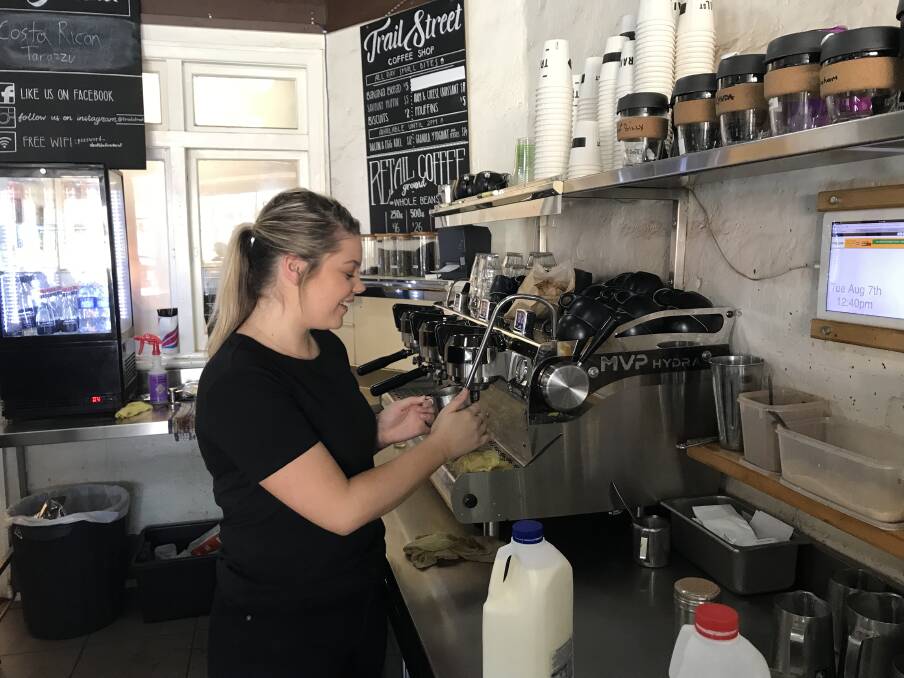 BUDGET STRETCH: University student and barista at Trail Street Cafe, Demi Lawler said she struggles to save on top of rent, bills, uni requirements and everyday expenses. Picture: Jess Whitty