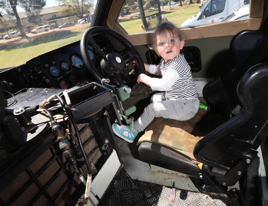 FOR EVERYONE: Wagga's Savannah Jaeger, 2, sat behind the wheel of a Bushmaster Protected Mobility vehicle at the Lightning Bolt II Invictus Convoy: Picture: Les Smith
