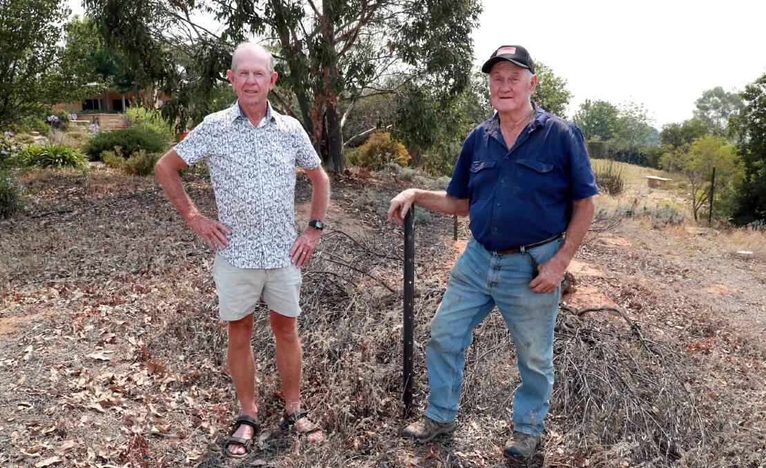 AT A LOSS: Gregadoo residents Malcolm Edgar and Jim Simpson say they can solve the lack of land supply with a subdivision that has the potential for an additional 3600 residential lots. Picture: Les Smith