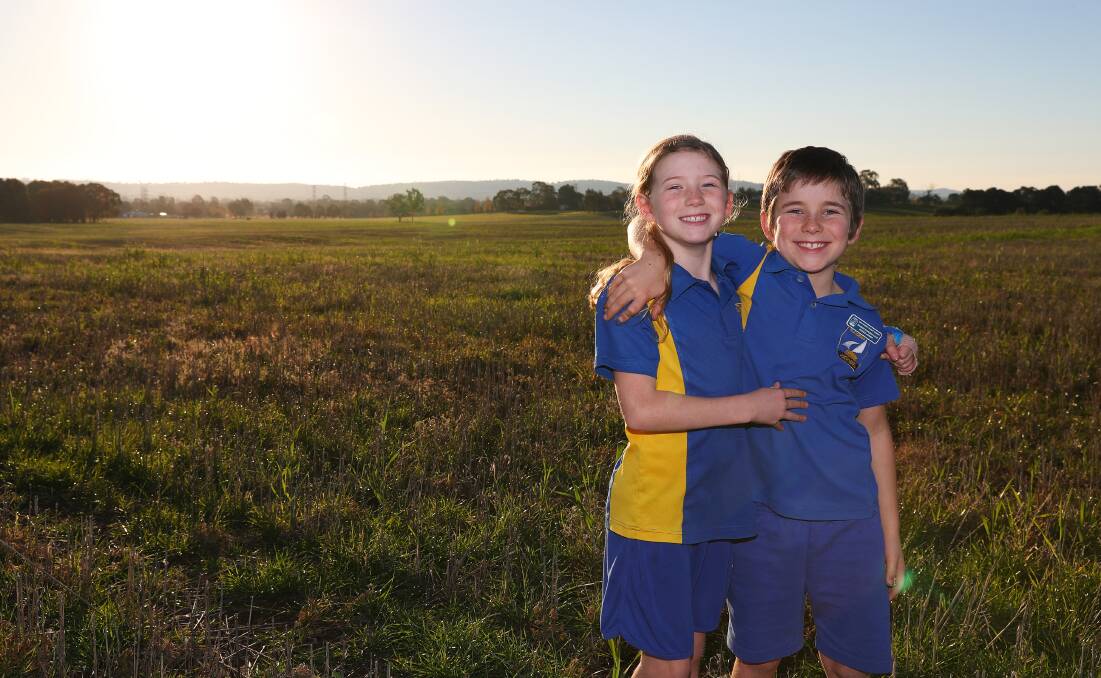 RURAL LIFESTYLE: Eight-year-old twins Xander and Jorjii McDonald say they love living on Butterbush Road because they have plenty of space to run around. Picture: Emma Hillier