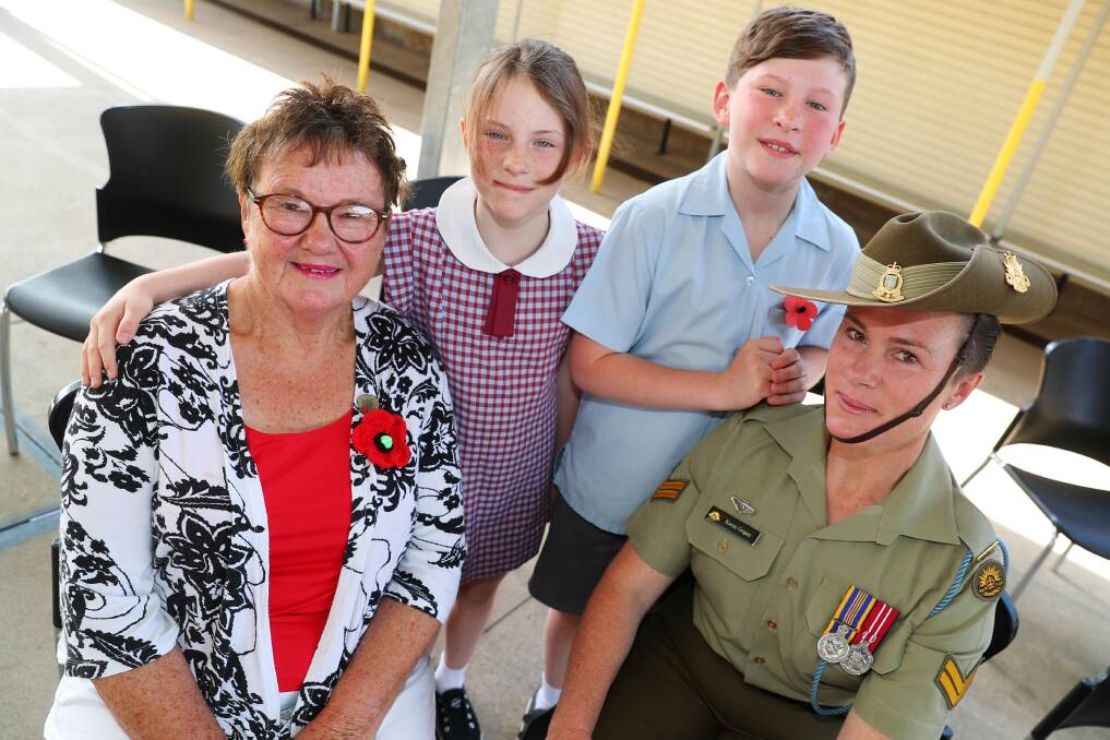 Rosemary Foley, Gwyneth Cregan, 9, Alfred Cregan, 11 and CPL Karen Cregan at the Remembrance Day commemoration at Kooringal Public School. Picture: Emma Hillier