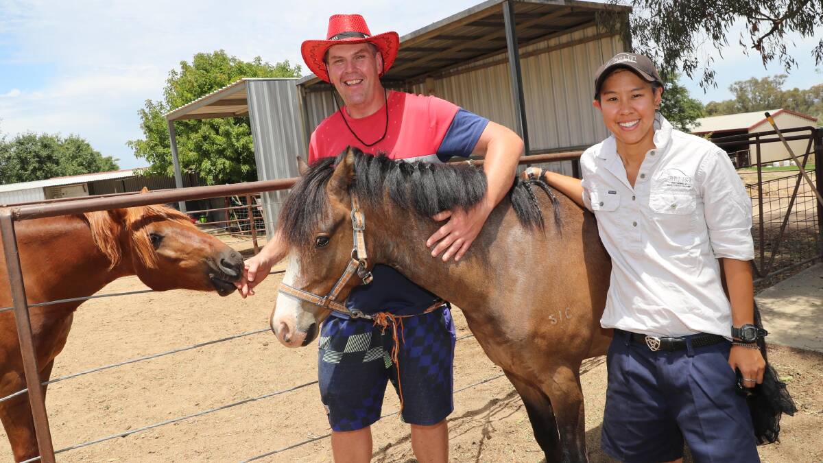 Bruce Eastam and Erika Neo with Duncan (middle horse) at the Belissi Equestrian Centre's Christmas lunch to mark the end of equine therapy courses. Picture: Les Smith
