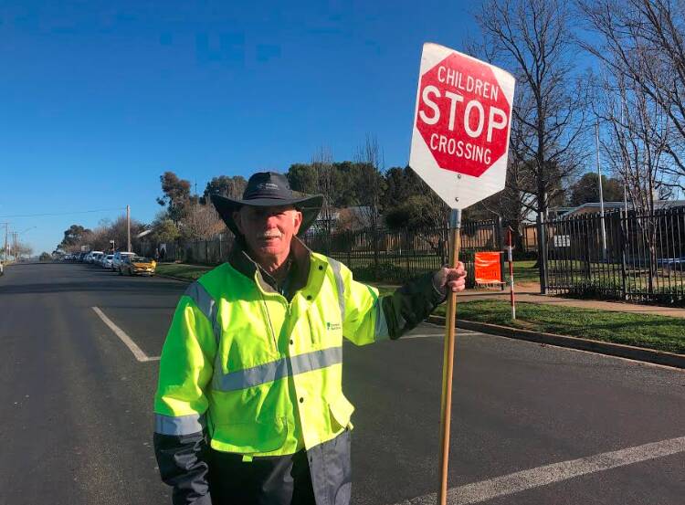 READY: Ashmont Public School's lollipop man Bernie Hinchcliffe says spreading smiles to students is one of his highlights each morning. 