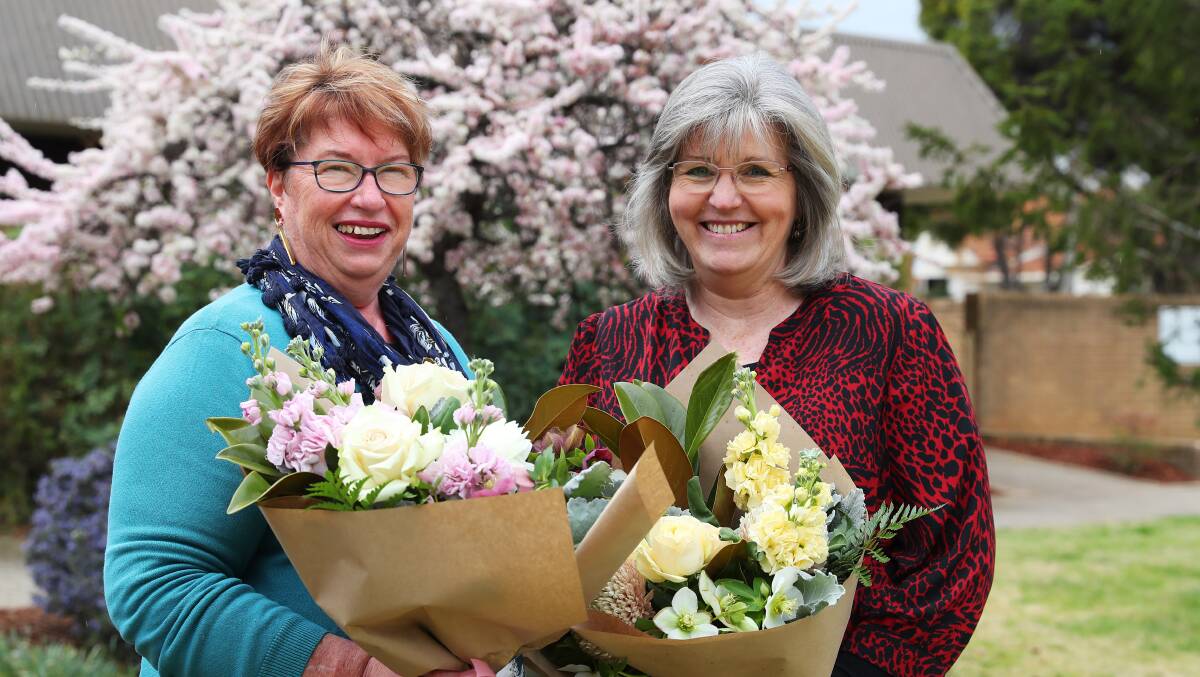 LOYAL STAFF: Manager Julie Logan and finance officer Sharon Froon celebrate a combined 50 years of dedication to Wagga's Meals and Wheels. 