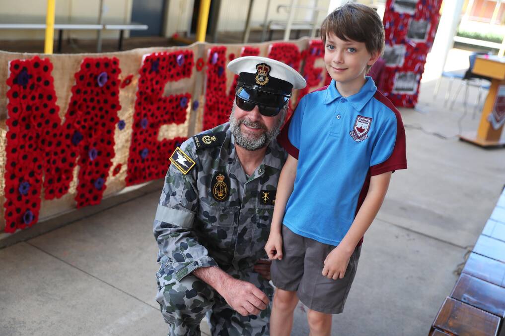 ANZAC CENTENARY: Chief Petty Officer Stewart Edwards and his son Michael, 10, were among defence families and students at Kooringal Public School's Remembrance Day event. Picture: Emma Hillier