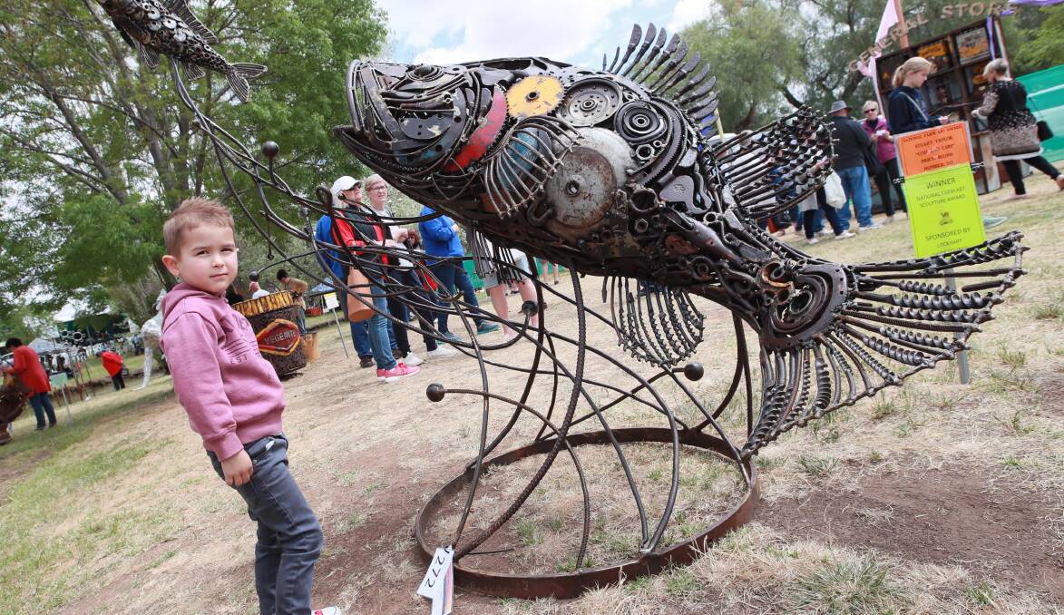 FAVOURITE: Ollie McGrath, 3, from Wagga, stands next to the winning sculpture: Stuart Taylor's Cod and Carp. Picture: Les Smith 