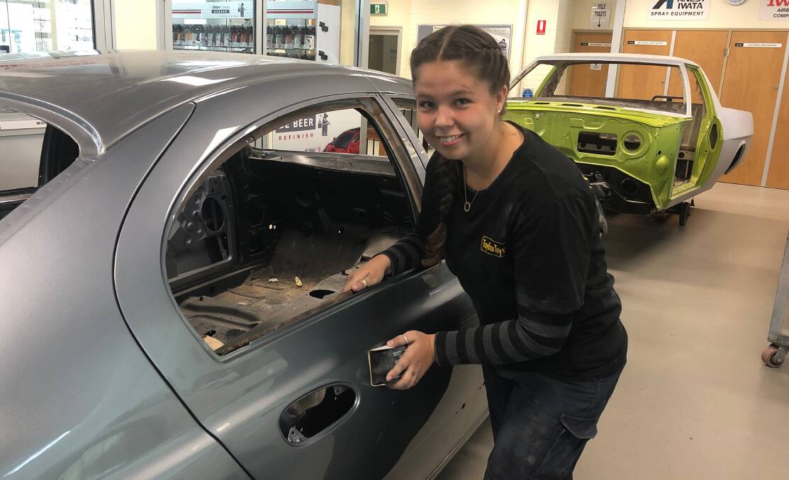 NEW PURPOSE: TAFE NSW Wagga spray painting apprentice Maddison Ross is working on an abandoned car that Wagga City Council impounded. Picture: Jess Whitty