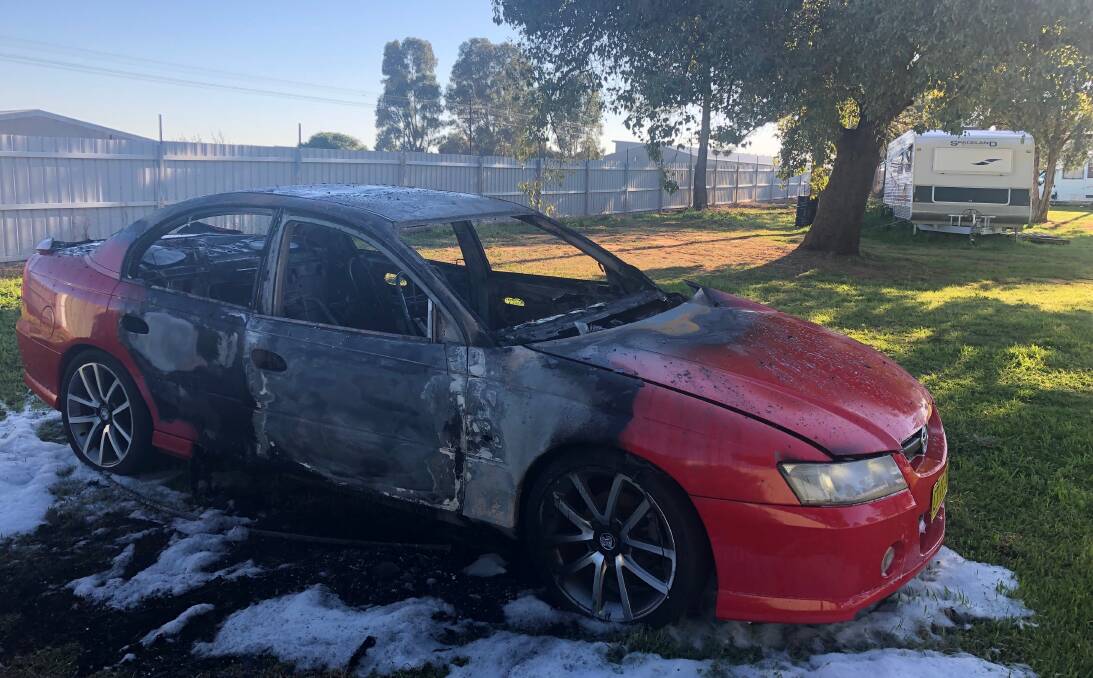 DESTROYED: Jason wakes up to find his Holden Commodore up in flames about 3.30 this morning. Picture: Jess Whitty