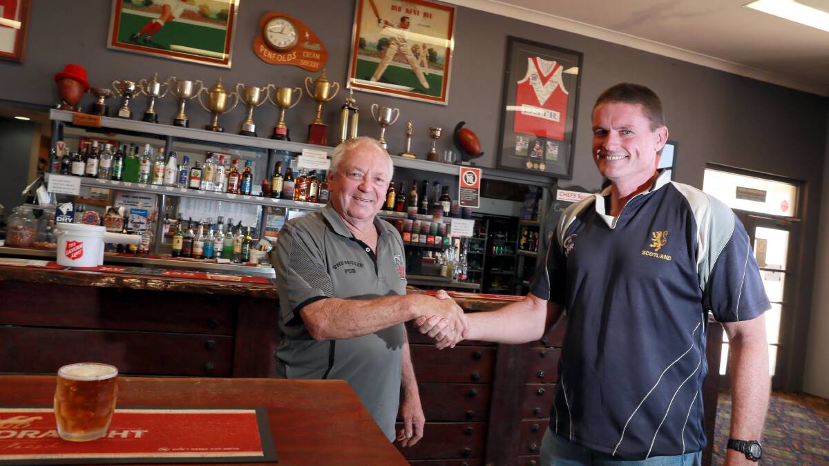 DONE DEAL: Russ Meyers is shaking hands Matt Quade, the new licensee of the Collingullie Hotel. Picture: Les Smith