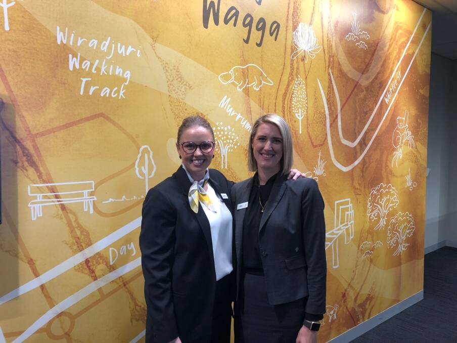 DRESS TO IMPRESS: CBA Wagga branch's regional general manager Sara Sutton and customer banking specialist Chloe Sainsbury show off the most significant uniform redesign in 15 years. 