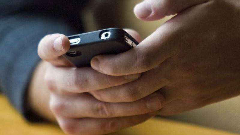 BAN: One Wagga parent says all NSW schools should follow Victoria and ban mobiles inside and outside the classroom during school hours. 