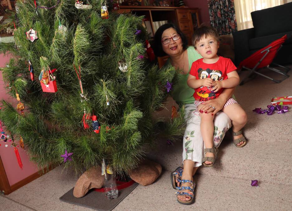 LEAD UP TO CHRISTMAS: Denise Flockton and her grandson Albert Shumack, 3, are decorating a real Christmas tree together. Picture: Les Smith