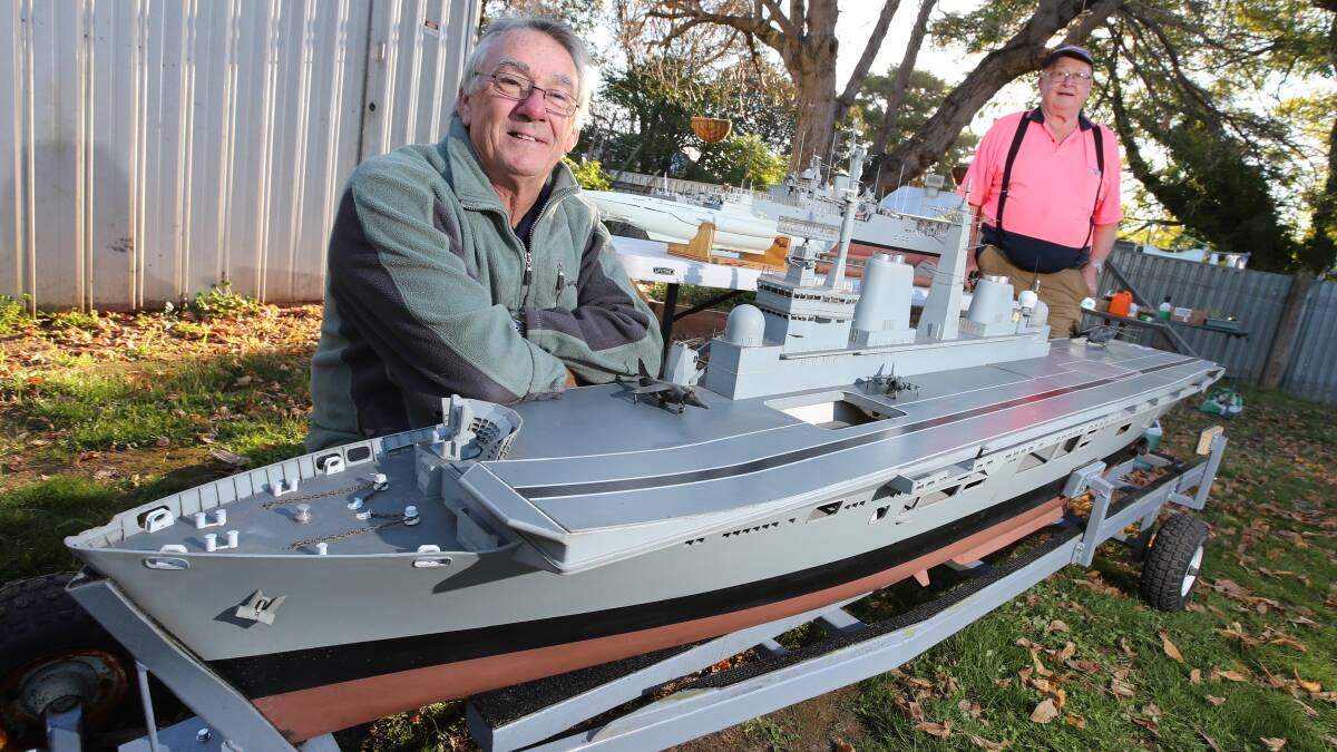 ON DISPLAY: Chris Rogers, from Caboolture in Queensland, with his two model replica ships, the HMS Plymouth (top) and HMS Invincible, both played roles in the Falklands War, and Brian McCrowe with his scale model World War 2 type 7 German U-boat. Picture: Les Smith
