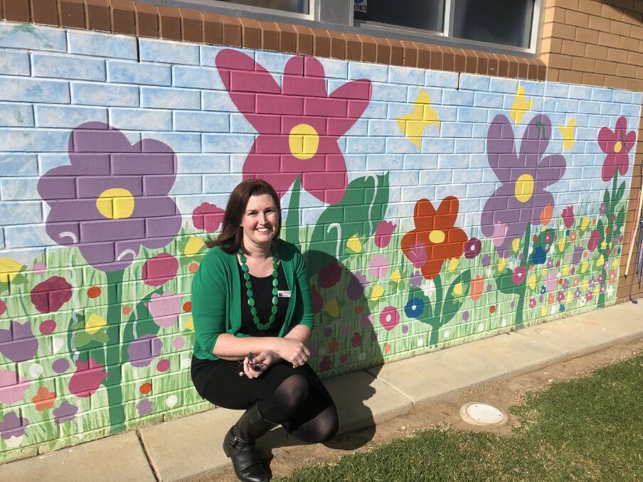 PRETTY: Bimbi preschool teacher Tiffany Shackleton, in front of the preschool's mural, said she loves the flexibility of the preschool curriculum and building relationships with the children. Picture: Jess Whitty