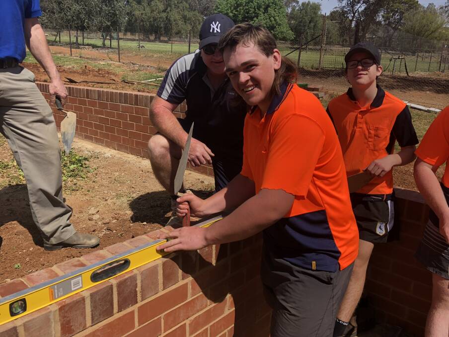 Year 9 student Jarred Kenny, 15, is learning the brick laying trade under the guidance of local brick layer Mick Clark. Picture: Jess Whitty