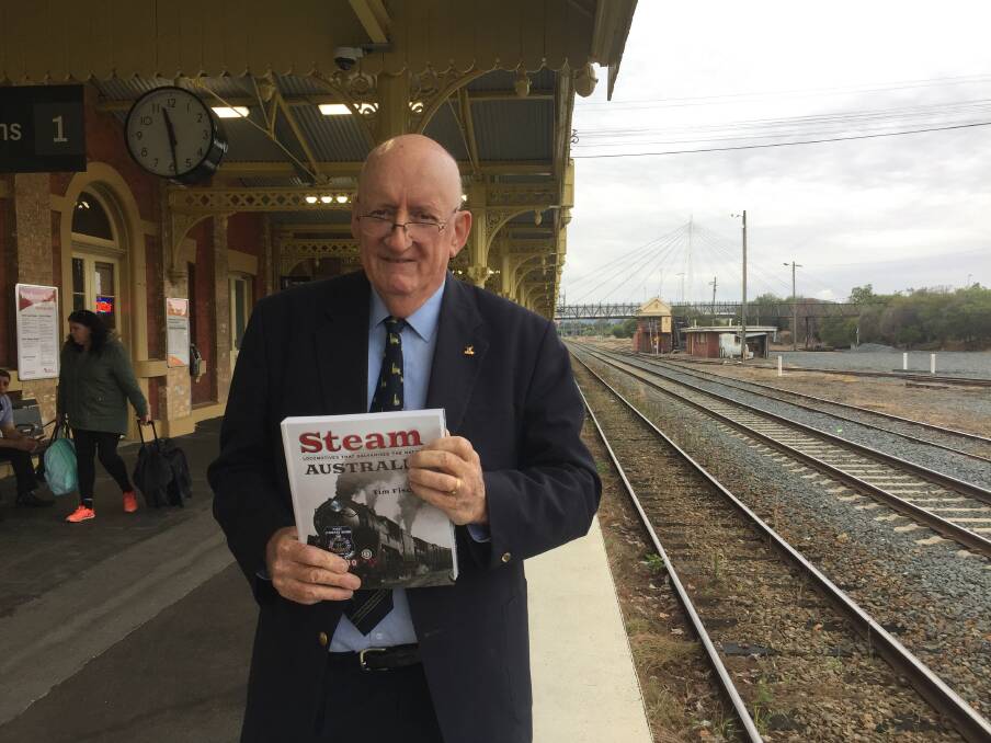 BOOK LAUNCH: Former Deputy PM Tim Fischer on the Albury railway station platform with his sixth book which examines great steam locomotives in Australian history.