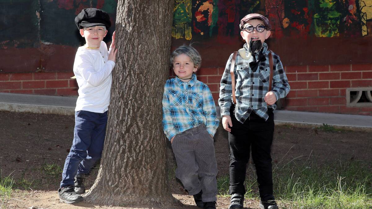 DRESS-UPS: Kindergarten students Harry Eade, Mitch McGuiness and Lincoln Krause dress up as 100-year-old grandpas. Picture: Les Smith