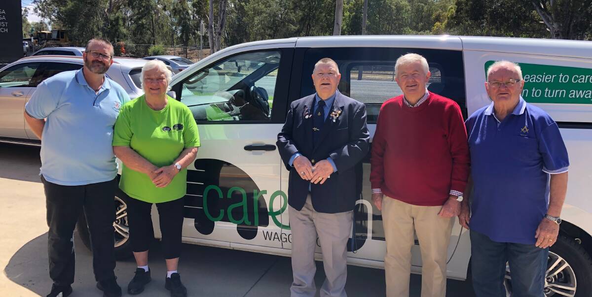 UNITING TO HELP: Wagga Masonic Lodge members Owen Sandry, Ross Reid, Stuart Heriot and Rick Priest hand over donations to Wagga Carevan project manager Lynne Graham to help those in need. 
