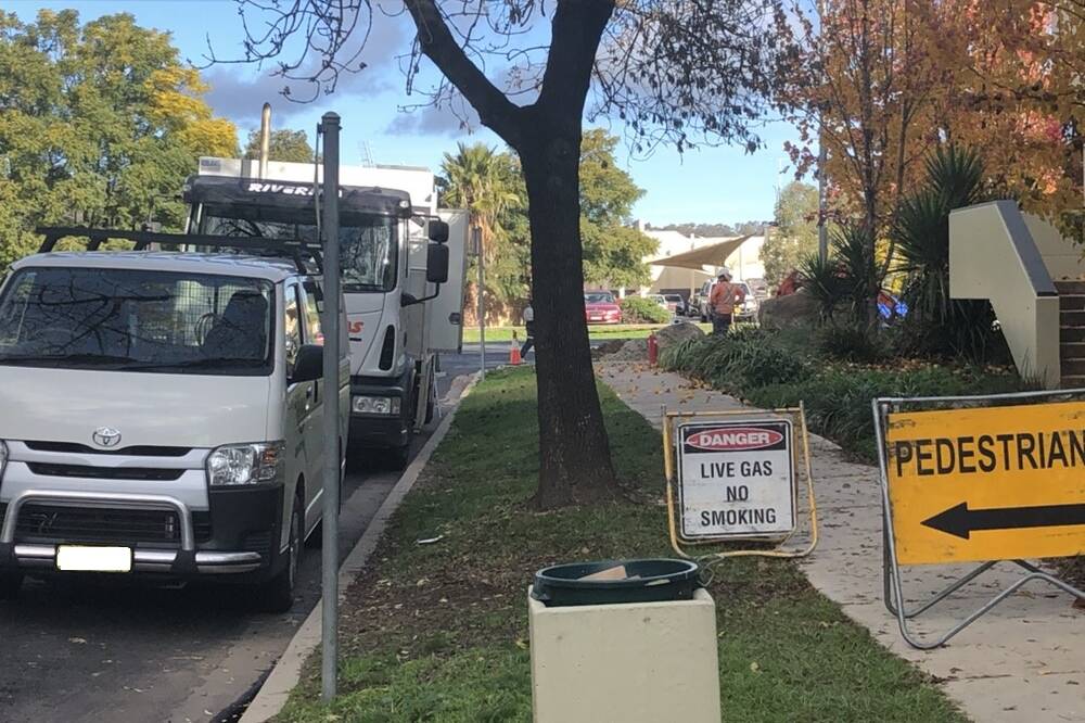 FOOTPATH BLOCKED: Pedestrians diverted as workers fix the believed underground gas leak. Picture: Jess Whitty