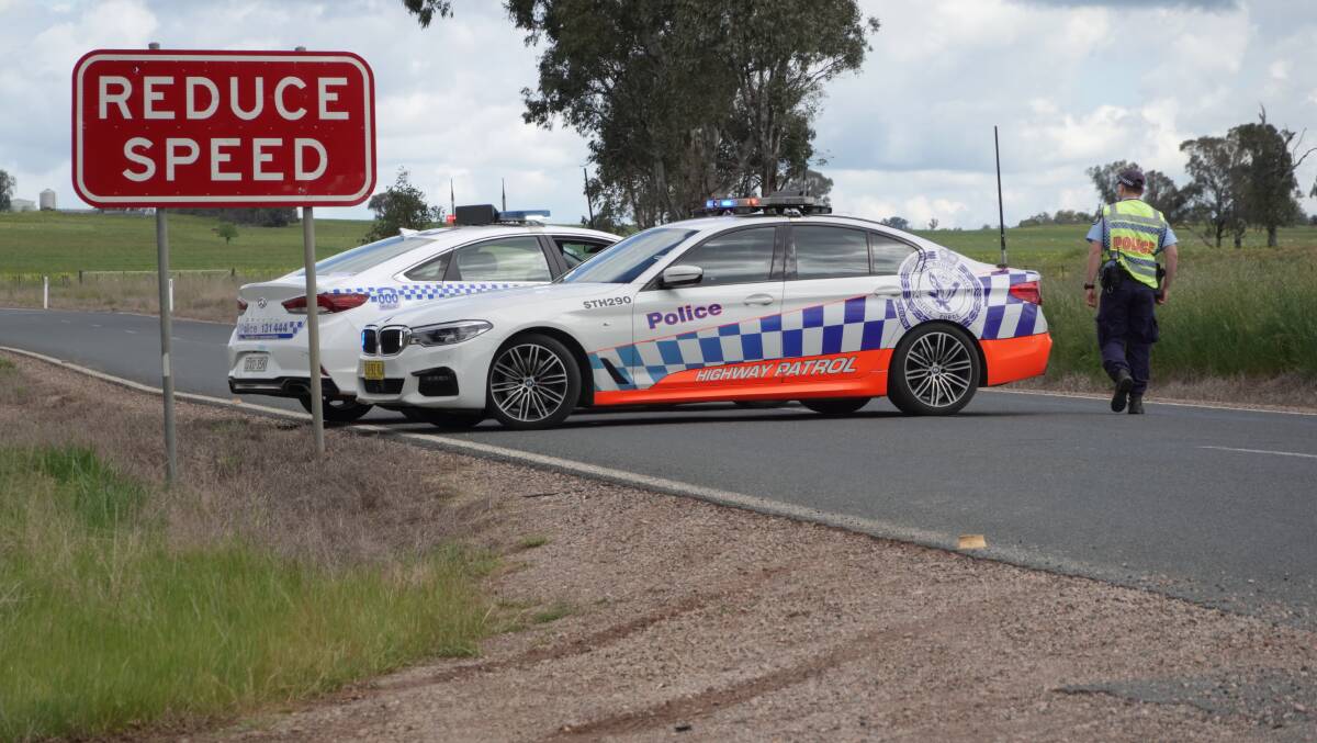 ROAD CLOSED: Highway patrol officers were blocking traffic on Holbrook Road following the accident on Saturday afternoon. Picture: Monty Jacka
