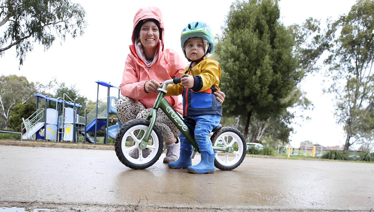 READY: Melissa Nichols and her son Jon, 19 months, were all kitted out for a rainy day at Wagga Beach on Wednesday. Picture: Les Smith