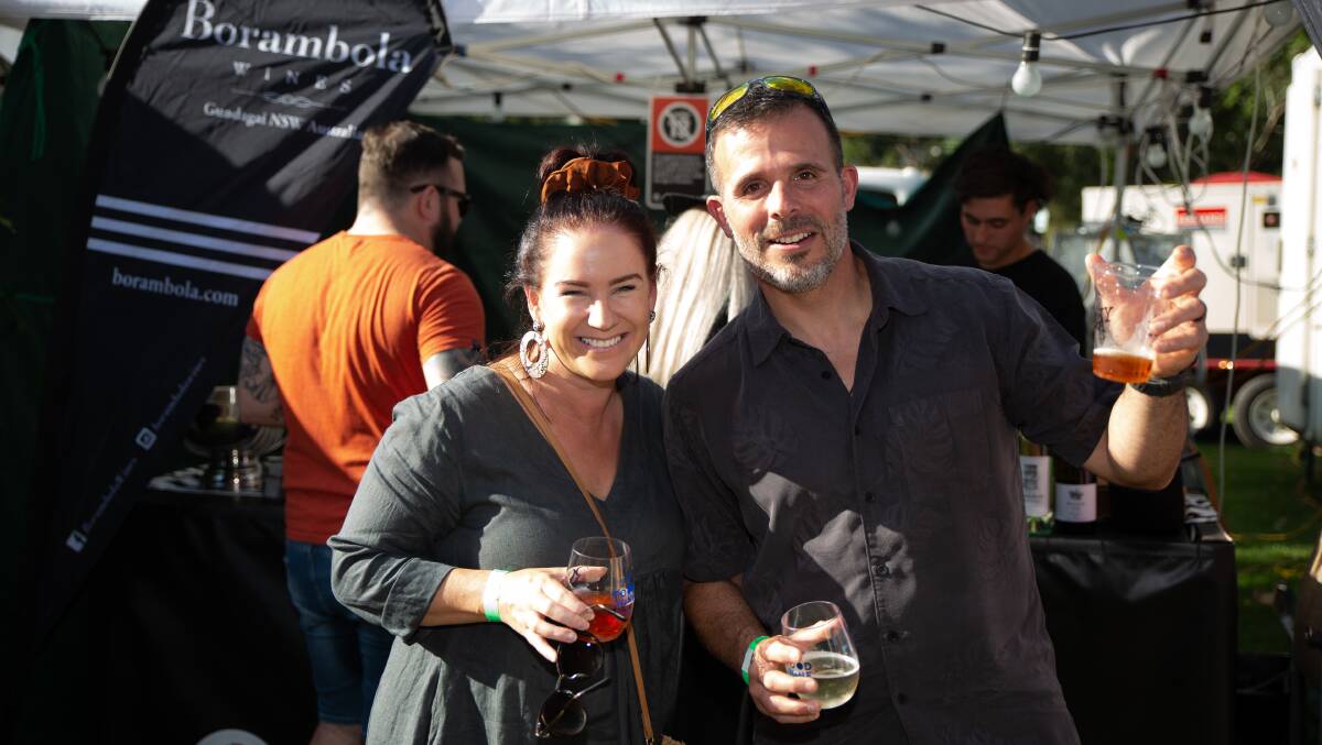 DELIGHT: Marney Gett and Rafael Garcia shortly after ordering a glass from Borambola Wines at the Wagga Food and Wine Festival. Picture: Madeline Begley