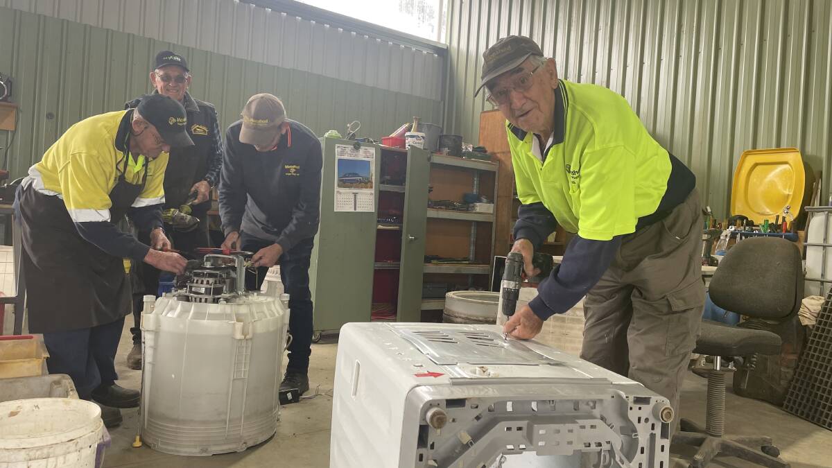FREEDOM: The Wagga Menshed's recycling team, including Basil Richardson (right), making the most of the extra room offered by their new workspace. Picture: Monty Jacka