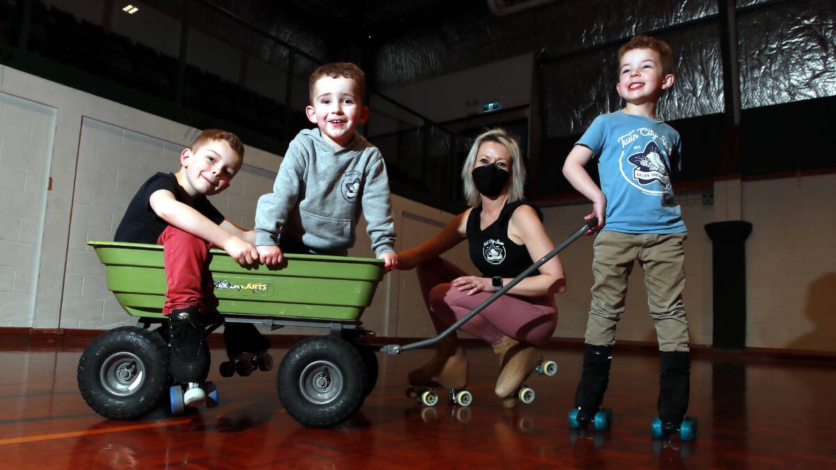 RETRO SKATING: Bec Wawszkowicz getting ready for the school holiday 'roller discos' with her children Max, Vin and Jude. Picture: Les Smith