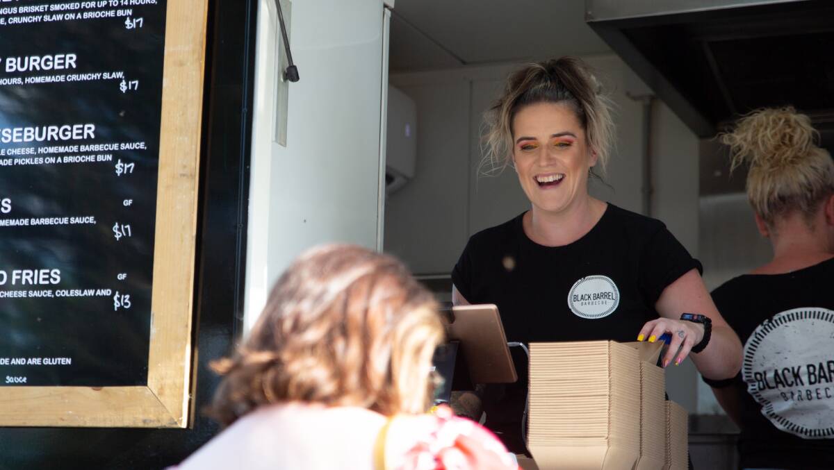STOKED: Aoileann Godde of Black Barrel Barbecue serves a customer at the first Wagga Food and Wine Festival held in the past three years. Picture: Madeline Begley
