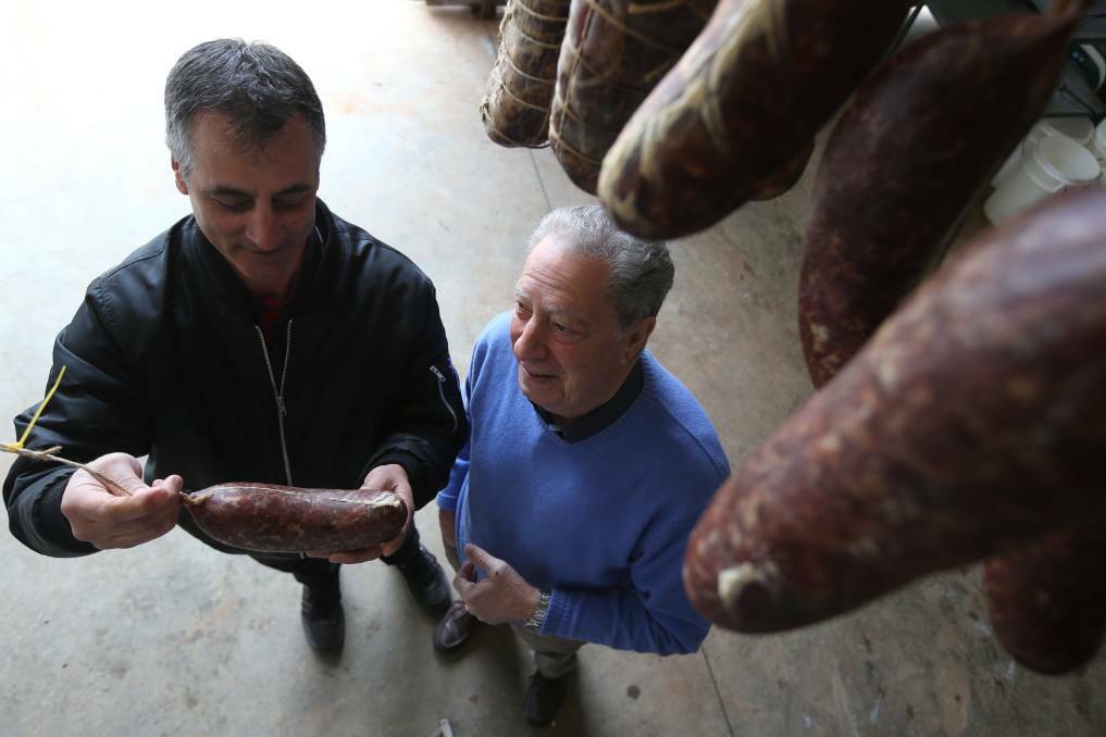 WEIGHING UP: Salami festival organisers Nigel Ippoliti and Roy Catanzariti preparing for the 2019 event, the last time the celebration took place. PHOTO: Anthony Stipo