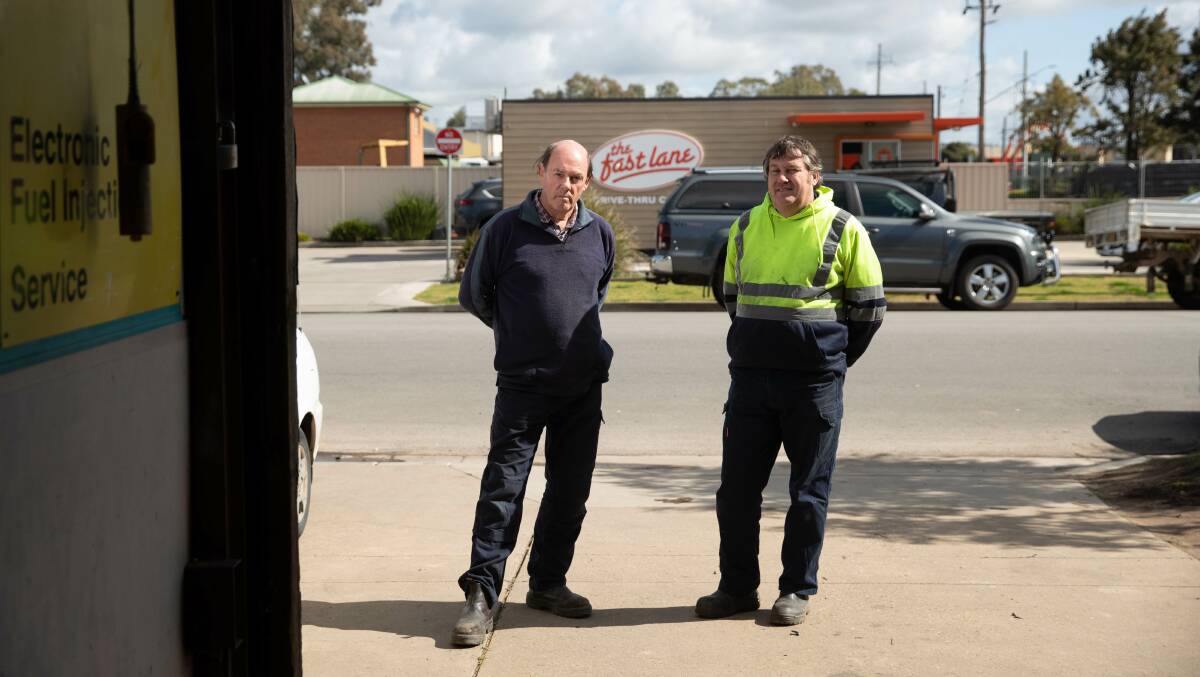 FRUSTRATED: Noel Crocker and Bruce Gillard say the long queues at Fast Lane Drive Thru regularly block the entrance to their garage. Picture: Madeline Begley