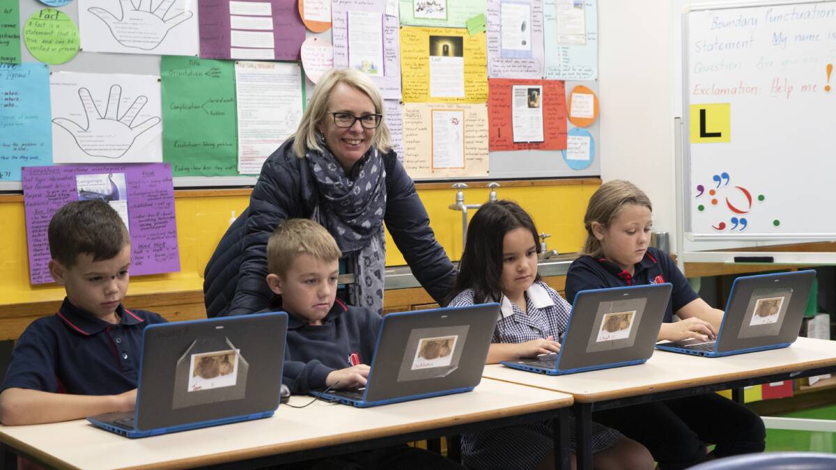READY: Red Hill Public School students Bailey Rolls, 8, Decklan Rutherford, 10, Dana Ratu, 7, and Summah Moore, 10, with their school's NAPLAN co-ordinator Kate Fox. Picture: Madeline Begley
