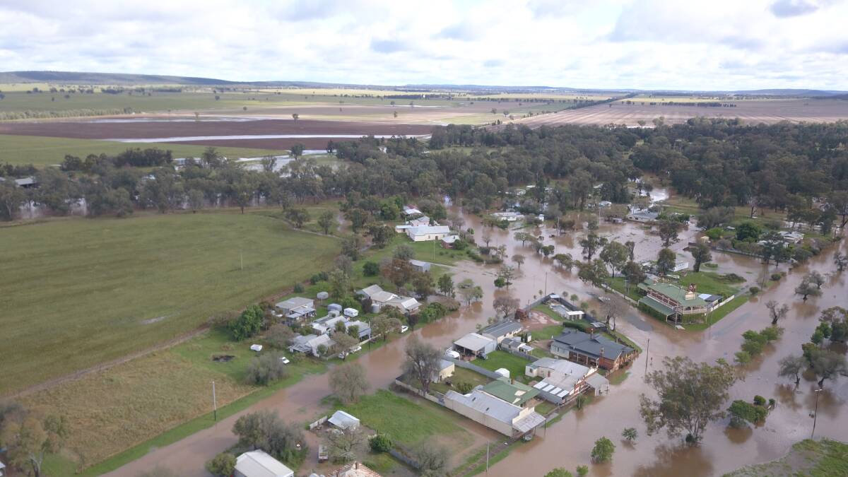 Water from the overflowing Mirrool Creek covered the roads in Beckom on Tuesday. Pictures by Phil Stewart
