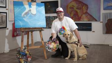 EXCITED: Wagga artist Joel Jensen with his guide dog Nicci ahead of his first ever solo art exhibition this weekend. Picture: Madeline Begley