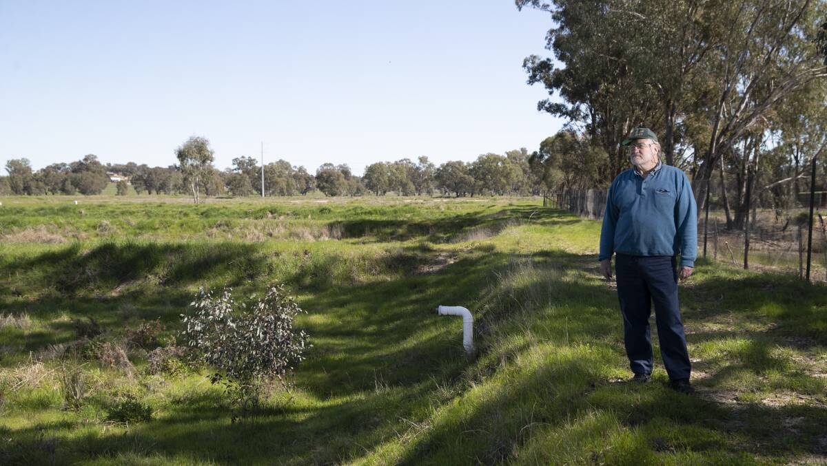 The ponds at the Murray Cod Hatcheries were once filled with water and fish, but now lie empty and overgrown as the business remains in limbo. Picture by Madeline Begley