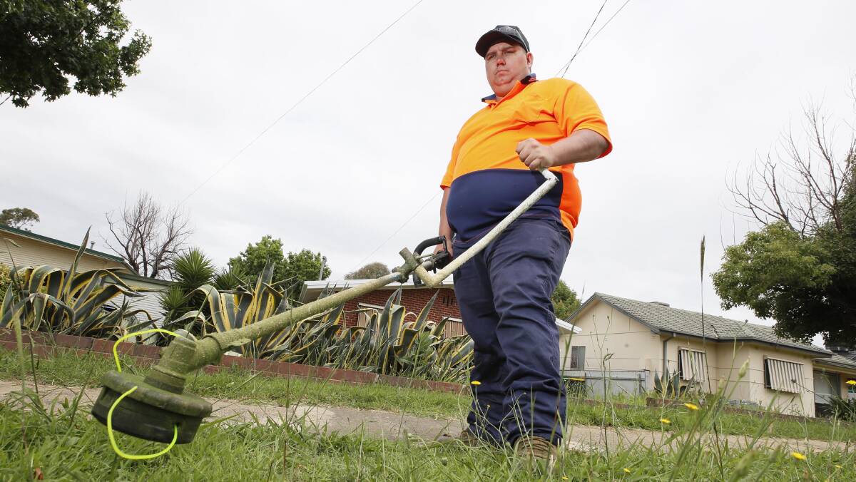 RELENTLESS: Kurtis Goodsell, the owner of Blades of Grass, has been "flat out" mowing Wagga lawns the last few weeks. Picture: Les Smith