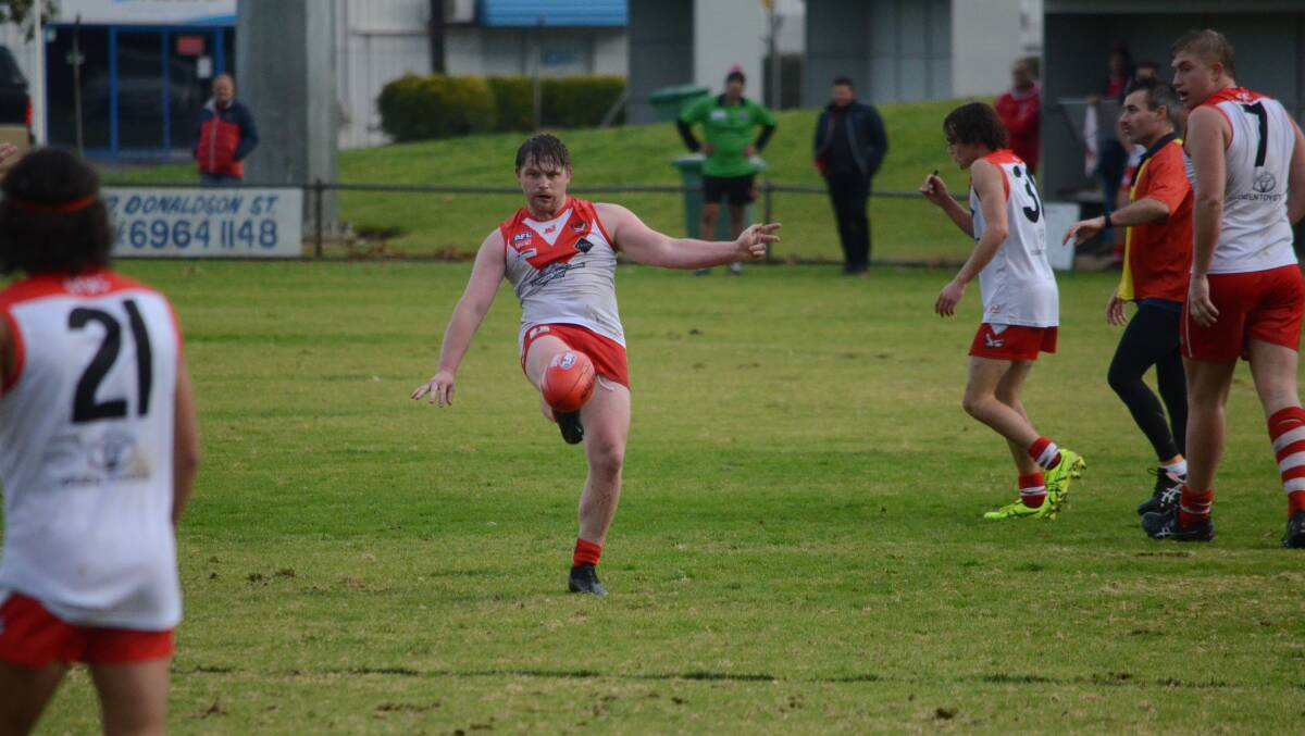 EFFORT: A soaking Thomas Powell scores a goal on a wet day out for the Griffith Swans against Collingullie GP. PHOTO: Monty Jacka
