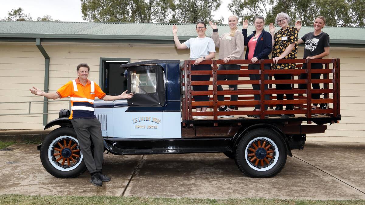 VINTAGE: Club member Rob Le Lievre - and his 1928 Chevrolet truck - was joined at the farewell by this year's Miss Wagga entrants Ashlee Janic, Marnie Gilmore, Ricki-Sue King, Courtney Harp and Haylee Burkinshaw. Picture: Les Smith