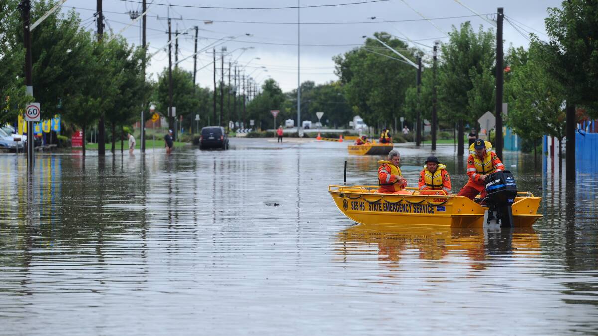 INUNDATED: Crews sail through the streets of Wagga during the 2012 flood. 