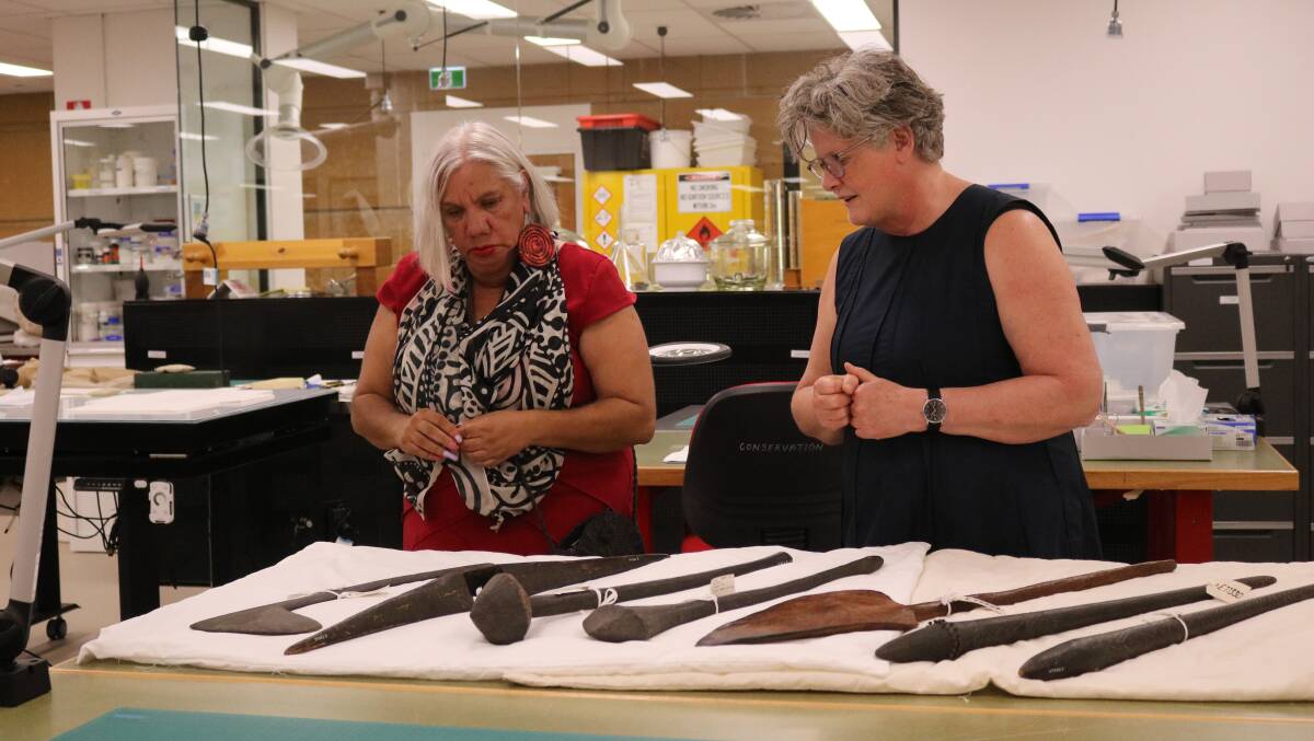 Wiradjuri elder Aunty Cheryl Penrith inspects the cultural objects at the Australian Museum, alongside Australian National University research fellow Robyn McKenzie. Picture supplied