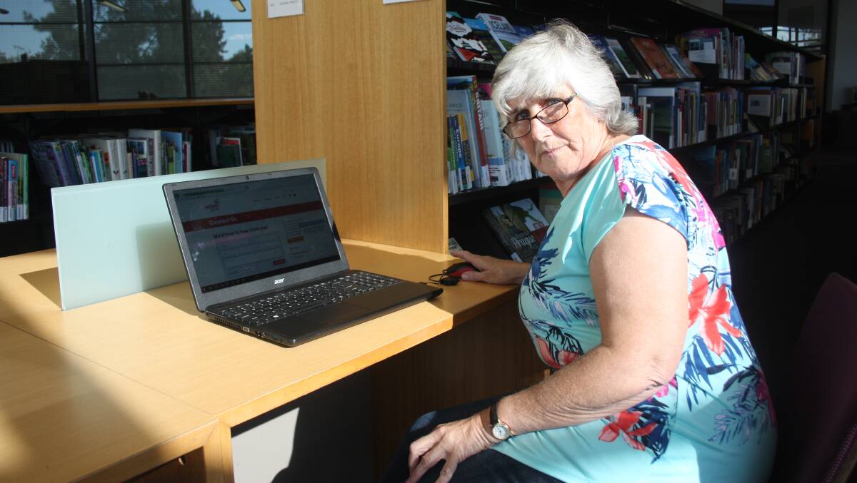 Jenny Chobdzynski has to work from the library because of continued NBN outages.