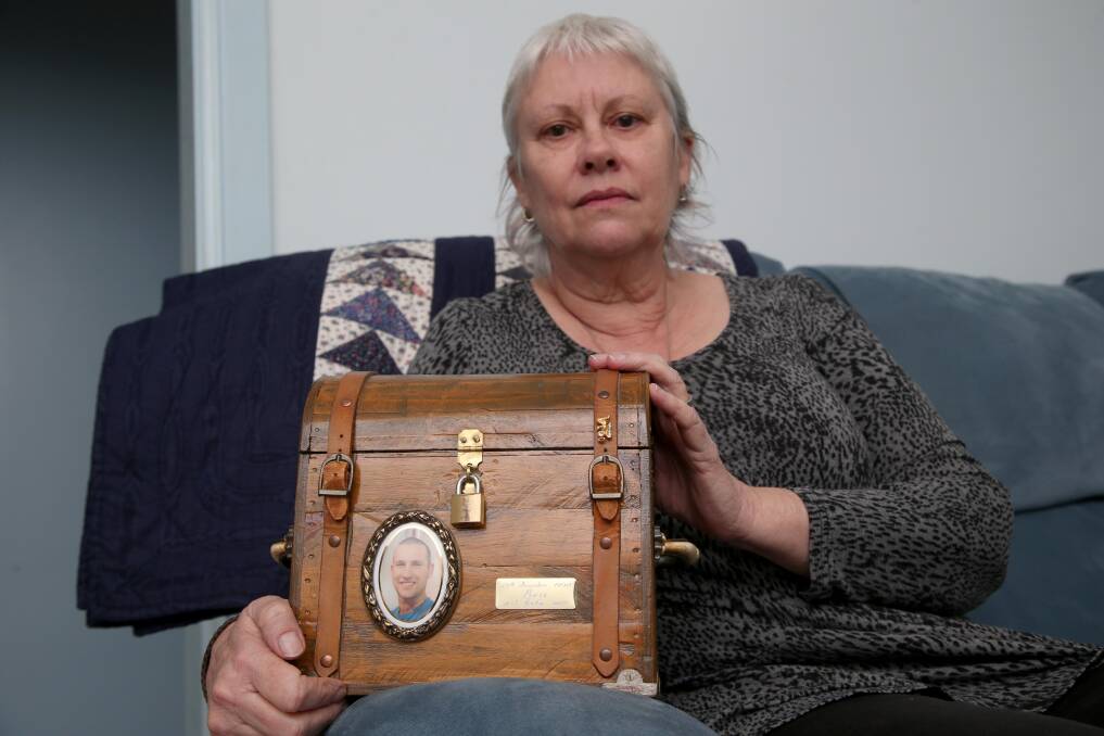 GRIEF: The loss of her son Ben is still raw for Kay Catanzariti, pictured holding his ashes at her home. Ben Catanzariti was killed by a falling boom in a workplace accident in 2012. Picture: Anthony Stipo