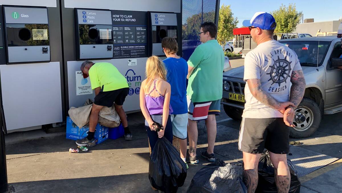 FAMILIAR SIGHT: People queue up to use the NSW government's reverse vending machine outside Kooringal Woolworths as Wagga approaches five millions containers recycled.
