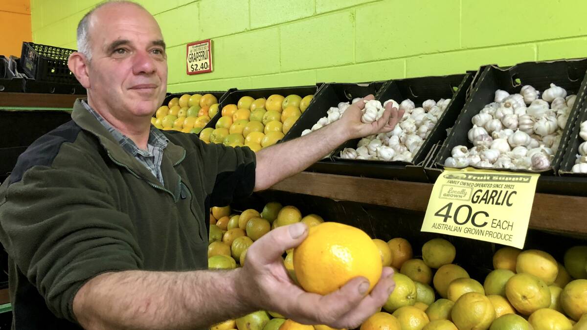 EAT LOCAL: Robert Papasidero shows off some of the Riverina produce on sale at Wagga Fruit Supply. He has welcomed an inquiry into fresh food pricing.