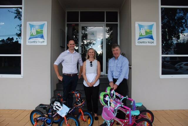 SUPPORT: Andrew Conkey and Carlie Henman from Sureway Skills Training with Country Hope representative Tom Looney and the gleaming new bicycles. 