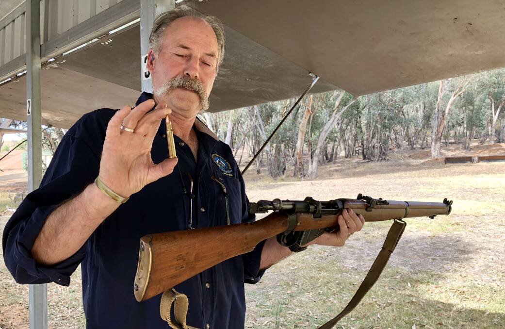 RESPECT: Greg Hannon from the Wagga branch of the Sporting Shooters Association of Australia shows the cartridge used in the Lee Enfield .303 rifle, which was used in both world wars. Picture: Stephen Mudd