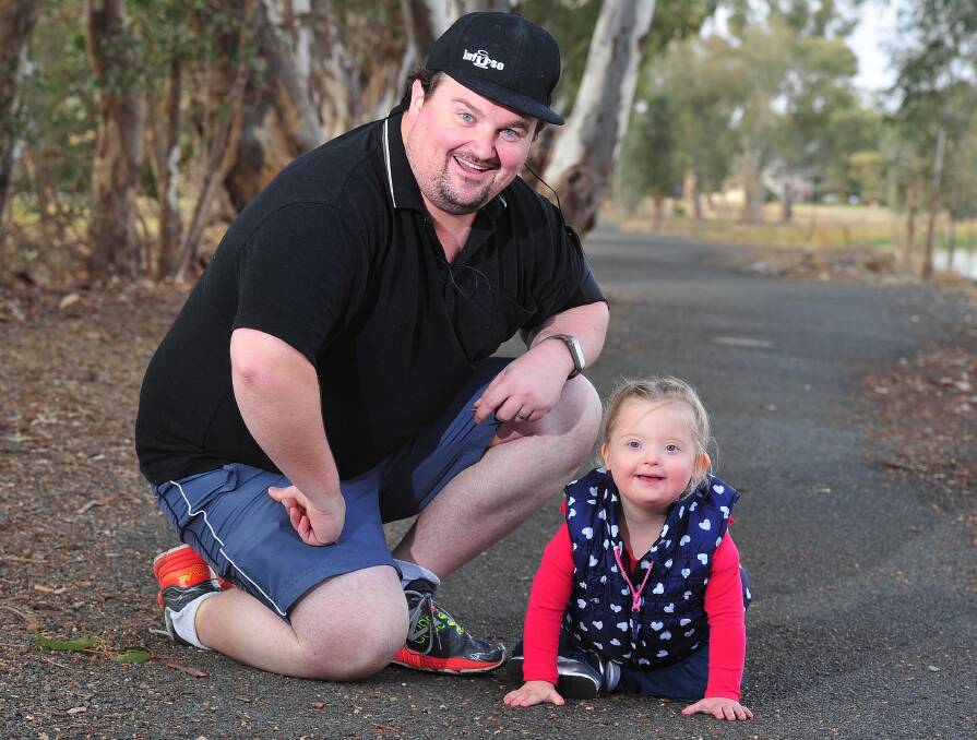 TEAMWORK: Jamie Way gets encouragement from daughter Sophie for a training run at Lake Albert. Jamie can often be seen running on the walking track training for a half marathon. Picture: Kieren L Tilly