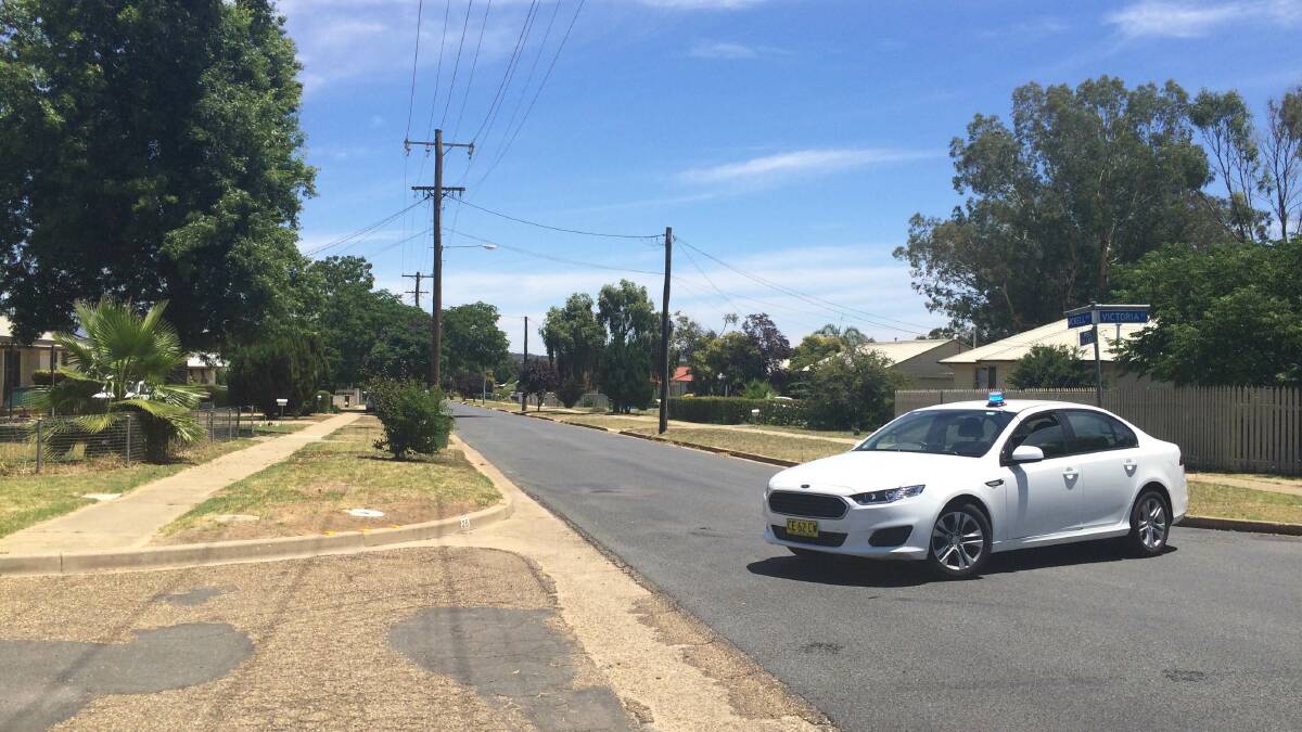 SIEGE: A police car prevents traffic from going near the siege situation. Picture: Brodie Owen