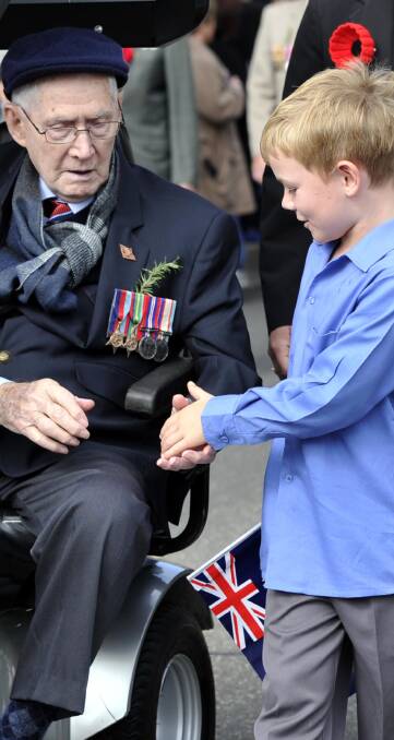THANKS, MATE: Judd Somerville, 8, marches with his great-grandfather Carl Thomas, who served in New Guinea during World War II. Picture: Les Smith