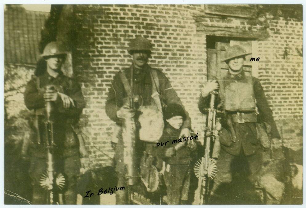 Fred McAlister (right) in Belgium with two other soldiers and a "mascot".